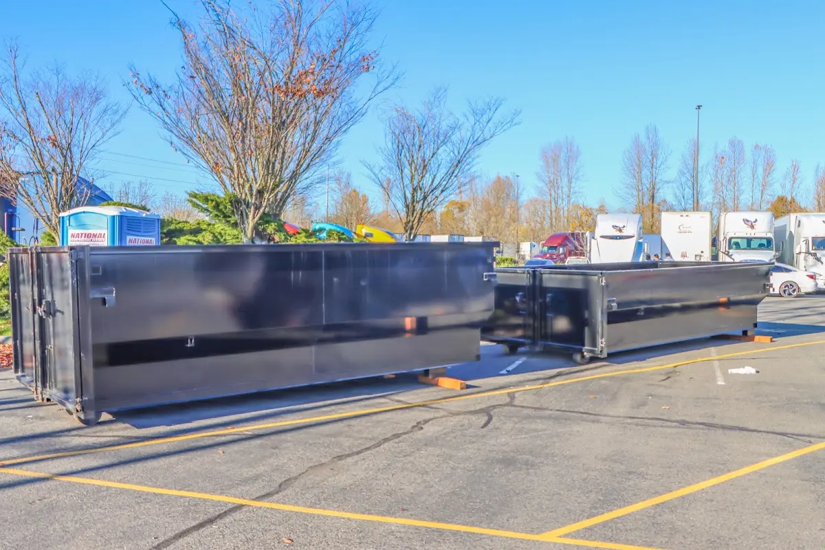 Professional dumpster rental service with roll-off container on residential driveway in North Versailles